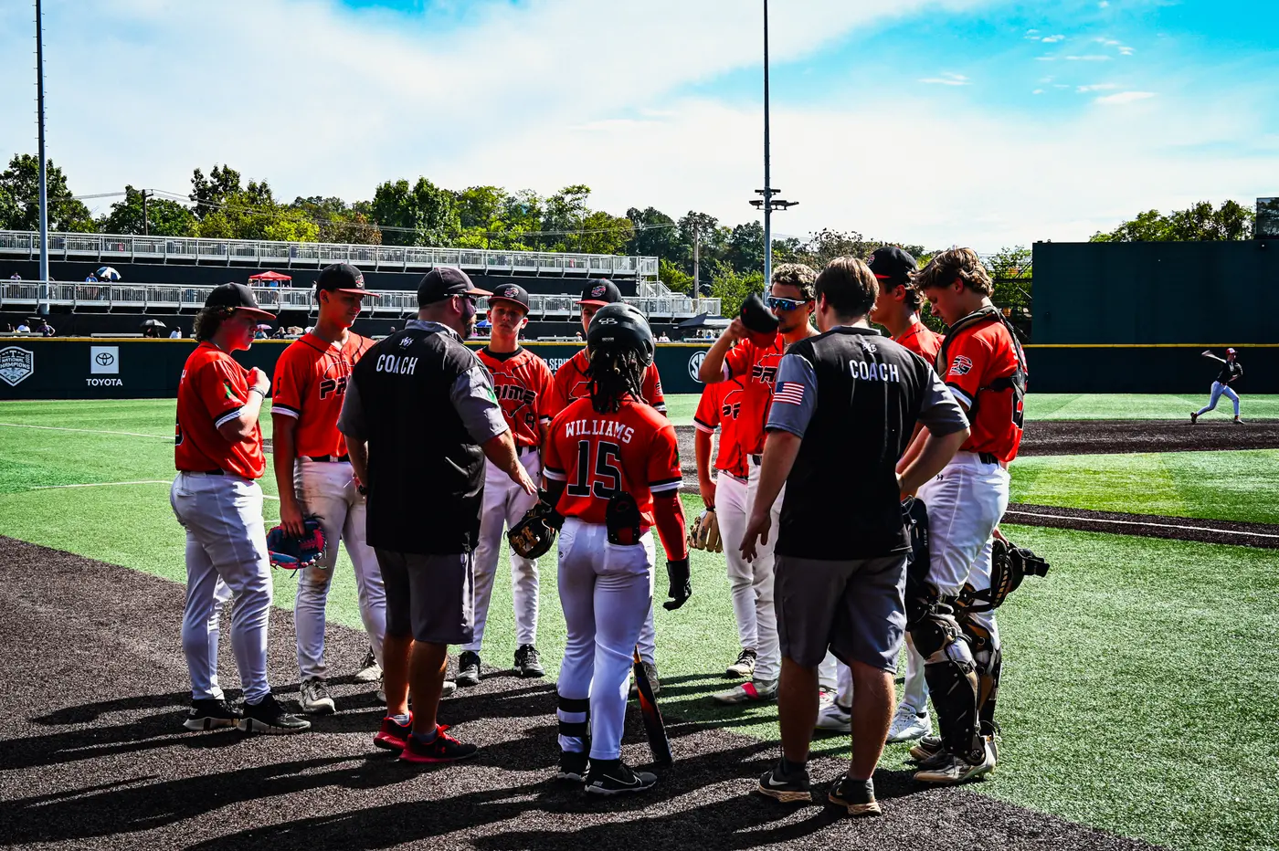 5G Prime National players and coaches in a team huddle