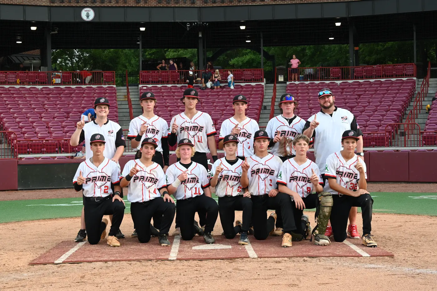 5G Prime National team posing together at a college stadium